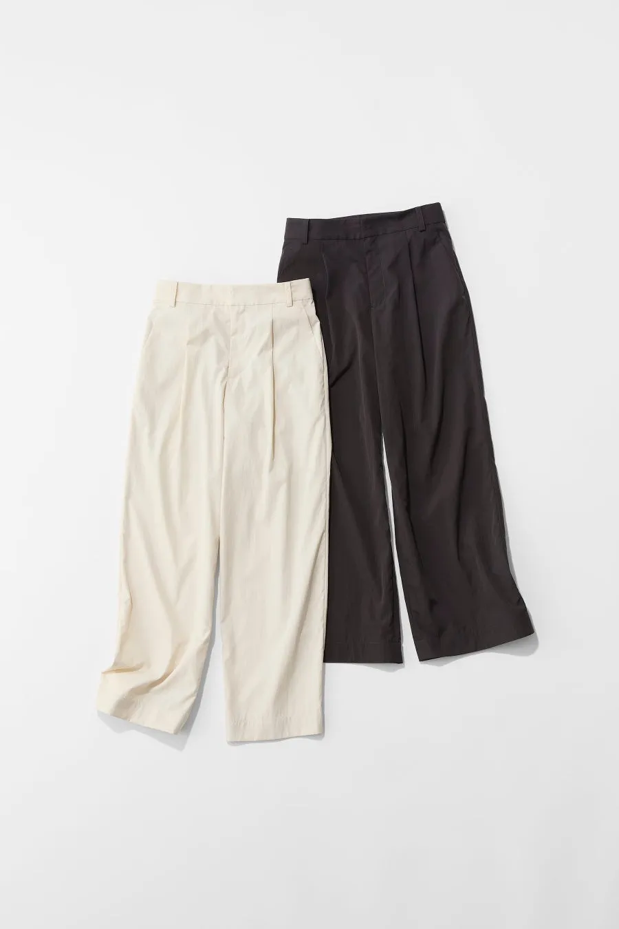 ベージュと黒のパンツが2つ並んだ画像です。